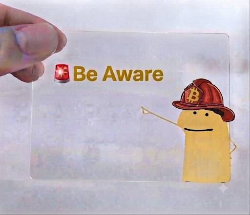 A hand holding a transparent card with '🚨 Be Aware' text and a cartoon Bitcoin character wearing a red firefighter helmet, pointing a stick.