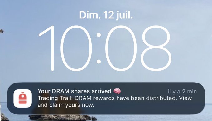 A smartphone lock screen at 10:08 on Sunday, July 12, showing a notification that reads 'Your DRAM shares arrived 🧠: Trading Trail: DRAM rewards have been distributed. View and claim yours now.'