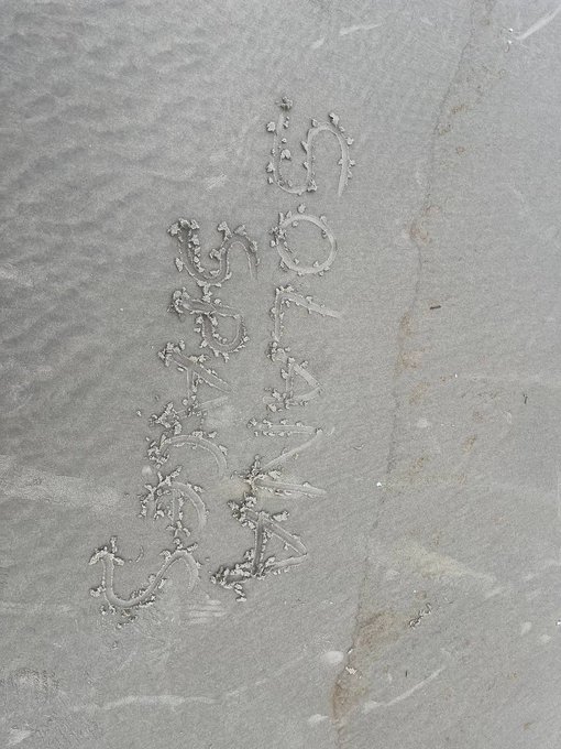 The image shows "SOLANA" written twice in what appears to be salt, sand, or a similar granular white substance arranged on a gray surface. The creative text art relates to the Solana Summit Nigeria event, likely serving as a celebratory or decorative memento from the final day of the conference.