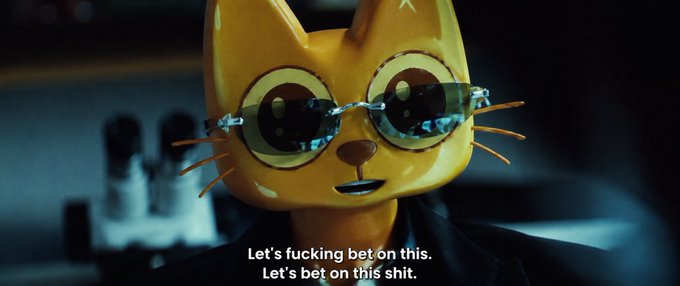 A 3D-rendered orange cat wearing glasses and a suit with the subtitle 'Let's fucking bet on this. Let's bet on this shit.'