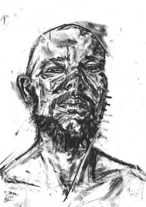 The image features a black and white portrait of a man with a beard, which appears to be drawn using charcoal or graphite. The man's face is prominently displayed against a stark white background, making him stand out. The style of the drawing suggests that it could be an oil painting, as it has a more realistic appearance compared to other styles like sketching or cartooning.