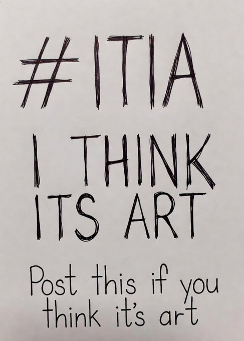 A handwritten sign in black marker reads '#ITIA I THINK ITS ART' with smaller text below stating 'Post this if you think it's art'.