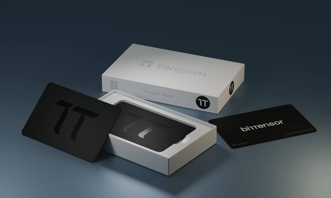 The image features a white box with black text that says "Tangem" on it. The box contains a wallet designed for use with the Tangem app, which is powered by Bitcoin. There are two wallets inside the box - one placed next to another, and both of them are in their original packaging. The post about the Tangem wallet encourages people to pre-order the product, as there are limited quantities available.