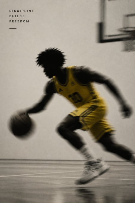 A silhouette of a basketball player in a yellow jersey dribbling, overlaid with the motivational text 'DISCIPLINE BUILDS FREEDOM.'