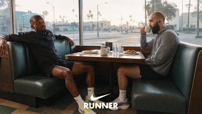 An advertisement showing two men sitting across from each other in a diner booth wearing Nike shoes and athletic wear, with the Nike 'RUNNER' logo at the bottom.