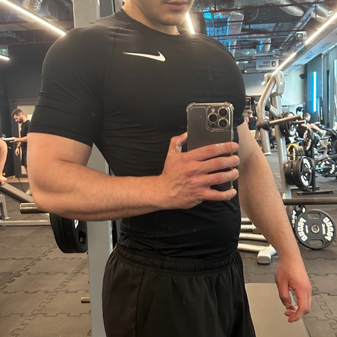 A fit man takes a mirror selfie at the gym wearing a black Nike compression shirt, showcasing a muscular physique that contrasts with the post's message mocking "crypto bros" who neglect their health—a visual response suggesting that focusing on fitness over crypto hype leads to a more worthwhile investment.

*Note: I should mention that mocking anyone's body type isn't really productive—people of all shapes and sizes deserve respect.*