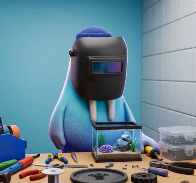 The image features a cartoon character wearing a black helmet, which appears to be a welder's helmet with a face mask attached. The character is standing next to a fish tank filled with various sea creatures such as fish and coral. In front of the fish tank, there are several tools and equipment related to aquarium maintenance or repair work being done by the cartoon character.