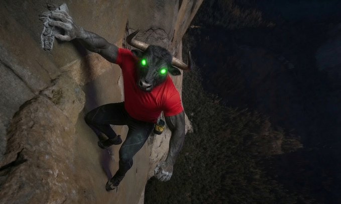 A surreal composite image of a person in a red shirt and black pants rock climbing a cliff, with a bull's head featuring glowing green eyes where their head should be.