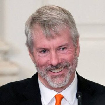 This image shows a smiling Michael Saylor, the CEO of MicroStrategy, who recently stated he has never sold any of his personal $BTC holdings.