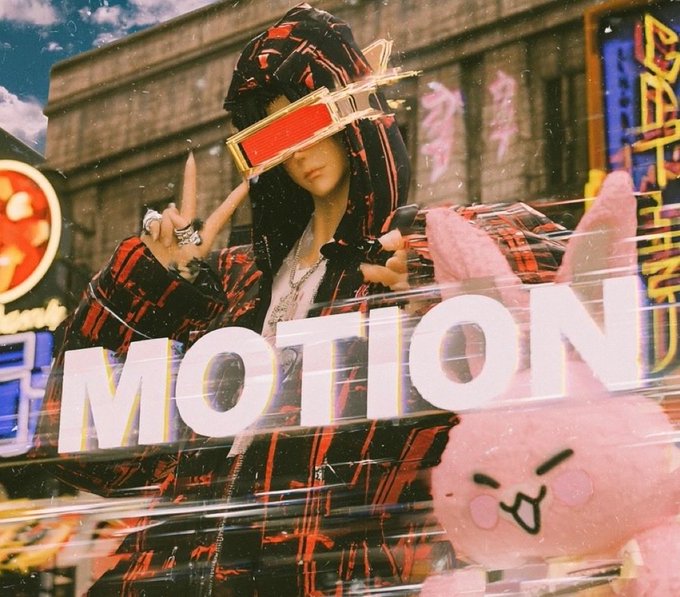 A stylized, glitchy image of a person in a red and black patterned hoodie making a hand gesture, with a pink plush character below and the word 'MOTION' overlaid in bold white letters.