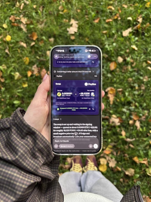 A first-person view of someone sitting outdoors holding a smartphone showing a chat interface with step-by-step instructions about swapping ETH on 'PayBox' using 'MetaMask' and 'Google Pay'.