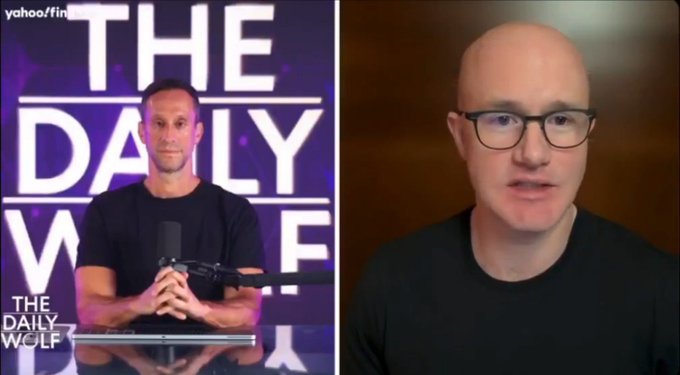 The image is a Yahoo Finance segment of "The Daily Wolf" podcast, featuring a host on the left and an interview with Coinbase CEO Brian Armstrong on the right, discussing his recent statement that the Bitcoin Clarity Act is effectively dead and urging the SEC and regulators to step up.