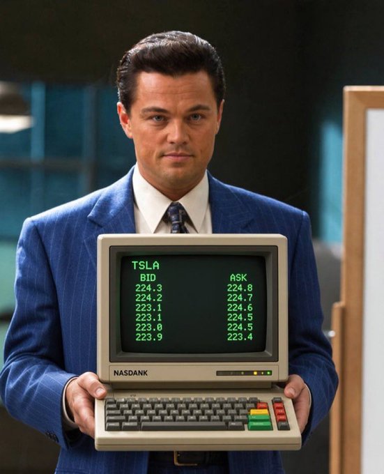 A man in a blue pinstripe suit resembling Leonardo DiCaprio from The Wolf of Wall Street holding a vintage NASDANK computer displaying TSLA stock bid and ask prices.