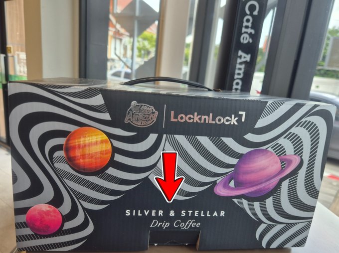 A black LocknLock promotional gift box featuring illustrations of planets (Sun, Saturn, Mars) with the text 'Silver & Stellar Drip Coffee' and a red downward arrow.