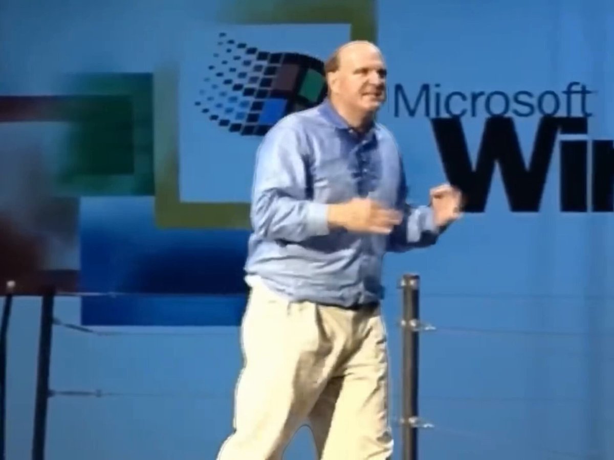 The image features an older man wearing a blue shirt, standing on stage with his hands up as if he's giving a speech or presentation. The background of the image shows a sign for Microsoft Windows, indicating that this event might be related to technology or computer-related topics. The caption provided in the image suggests that there are multiple institutions offering different tokenization strategies and requirements for their security tokens, but they all have the same basic structure.