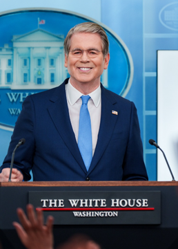 The image shows a man in a blue suit and tie smiling at a podium labeled "THE WHITE HOUSE WASHINGTON," with the White House logo visible in the background. The post's reference to "#ClarityAct" suggests this may be a staged or satirical photo used to comment on political prediction markets or legislation, though no specific text or numbers tie it directly to the Clarity Act topic.