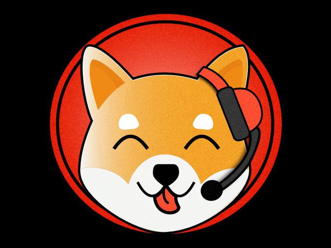 A cheerful cartoon Shiba Inu dog wearing a headset smiles against a red circular background, representing the $SHIB cryptocurrency community and its friendly, communicative spirit.