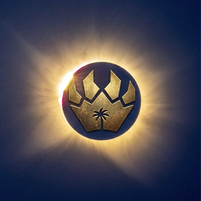 A glowing circular emblem featuring a golden crown with a palm tree symbol at its center, set against a dark blue background with radiant light bursting outward from behind it.