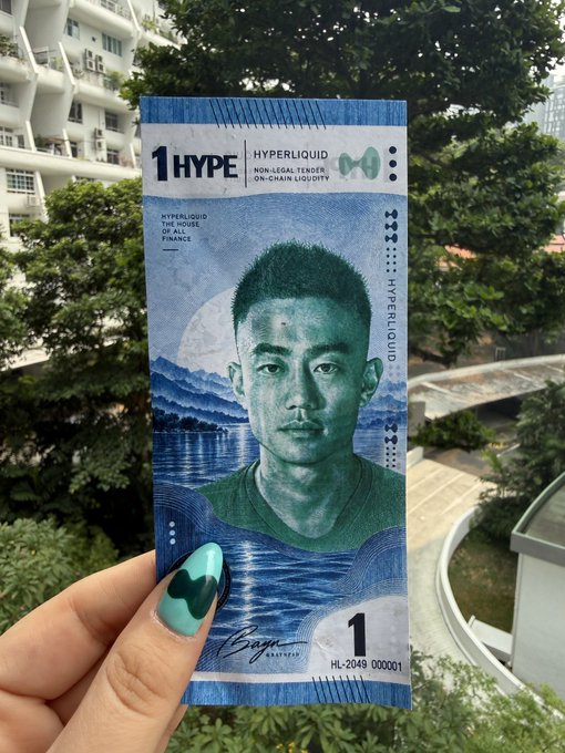 A hand holding a '1 HYPE' Hyperliquid non-legal tender on-chain loyalty note featuring a portrait of an Asian man, with the serial number HL-2049 000001.
