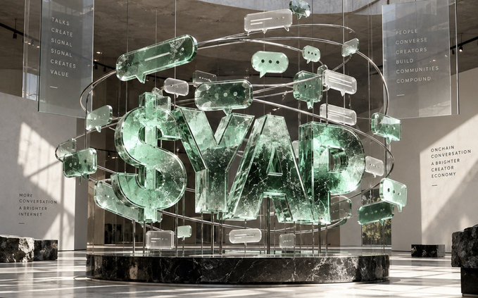 A digital art installation displays the large text "$MAD" in shattered glass lettering, surrounded by floating speech bubbles and signs with text including "TALKS CREATE SIGNAL" and "PEOPLE CONVERSE CREATORS BUILD COMMUNITIES COMPOUND".