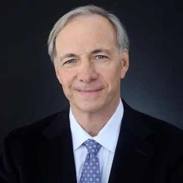 A professional headshot of an older man with gray hair wearing a dark suit, white shirt, and patterned tie, smiling at the camera against a dark background—appearing to be a corporate portrait of Ray Dalio, the billionaire investor referenced in the quote advocating for a 15% Bitcoin allocation in investment portfolios.