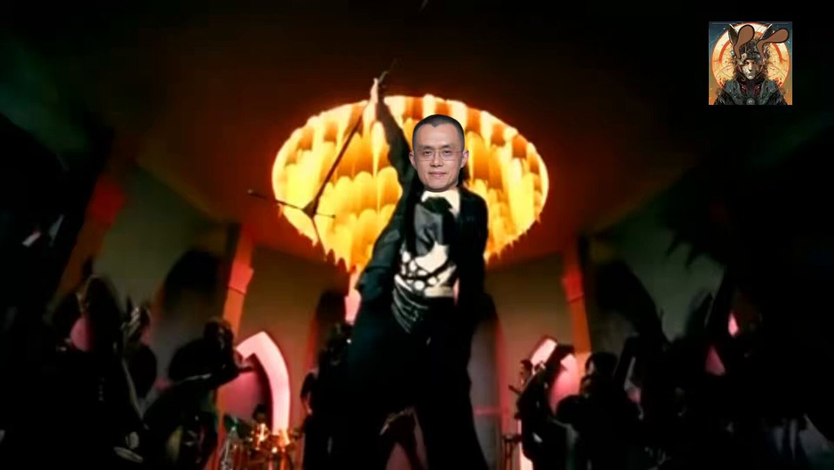 The image features a man dressed in a suit, holding a microphone and standing in front of a large light source that appears to be a chandelier or a lamp with multiple layers. The background shows several people gathered around him, suggesting this is an event or performance taking place. The caption for the image reads: "A Poem: 'Light Source' Dedicated to Cousin Da and Yi Jie".