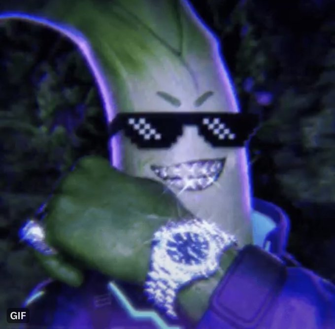 A whimsical GIF featuring a banana-like character wearing pixelated 'thug life' sunglasses and a large diamond-encrusted chain necklace, giving a thumbs-up gesture.