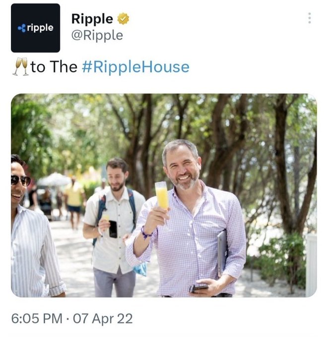 A Twitter post from Ripple (@Ripple) dated 07 Apr 22 at 6:05 PM, with the text '🥂 to The #RippleHouse' showing a man in a purple shirt holding a champagne flute.