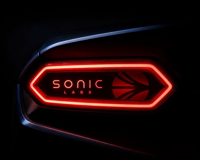 A close-up of a car tail light with red LED illumination displaying the 'SONIC LABS' logo and a basketball icon against a dark background.