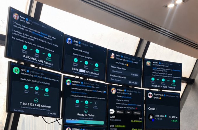 A photograph of multiple computer monitors displaying various social media posts, primarily Twitter/X, celebrating 'AXIS Claimed' airdrops with different user accounts showing large token allocations.
