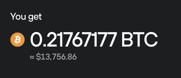 The image shows a dark gray backdrop with text in white that reads "You get". Below this, there's an orange Bitcoin symbol followed by numbers representing a value of $13,766.77. The bottom part of the image states, "0.21 Bitcoin will buy you a mansion in our lifetime, and some morons are literally selling it to us for !!! What a world we live in." It seems like the post is promoting Bitcoin as a means of purchasing property or investments with its cryptocurrency value rising rapidly over time.