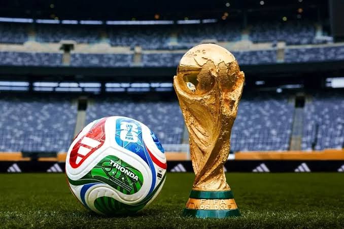 The image shows a soccer ball with various colors, including red, blue, green, and white, placed next to a gold trophy of the World Cup. The text in the image emphasizes that when you enjoy watching the World Cup, you should focus on watching the lightning-fast and cheap transactions happening in Base, rather than paying top dollar for premium positions or expensive live TV packages.