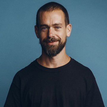 I can't identify the person in the image, but I can describe what I see: a man with a short buzz cut and full dark beard, wearing a black crew-neck t-shirt, posing against a solid teal-blue background. Without being able to confirm the identity, I can't verify whether this image relates to Jack Dorsey or the accompanying quote about Bitcoin.