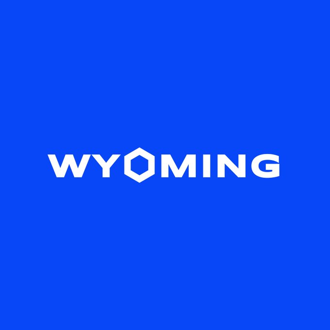 A blue graphic displaying the white 'WYOMING' logo with a hexagon forming the 'O'.
