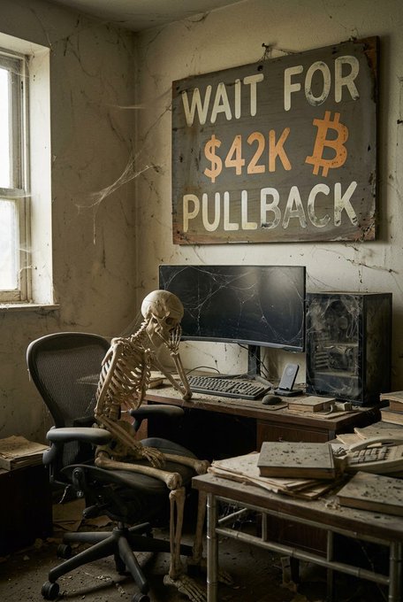 A weathered sign reading "WAIT FOR $42K PULLBACK ₿ PULL BACK" hangs above a skeleton slumped at an abandoned, dust-covered computer desk—satirically warning Bitcoin holders who keep waiting for lower prices that they may end up missing the rally entirely. The image visualizes the post's message: "Don't be that guy. Stack Bitcoin."