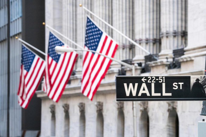 American flags wave outside a building above a Wall Street sign reading "WALL ST 22-51," reflecting the New York financial district setting for the announcement of the new S&P Pantera Digital Asset Index.