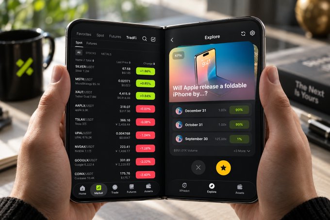 A person holds open a foldable device displaying XT TradFi's market screen showing tickers like SILVER/USD, MSTR/USD, and AAPL/USD alongside an XPredict prediction market asking "Will Apple release a foldable iPhone by...?" with dates December 31, October 31, and September 30. The dual-display setup visually embodies the post's "market Duo" concept, showcasing how the two apps work side-by-side on a foldable phone to help users read global markets and predict future events.