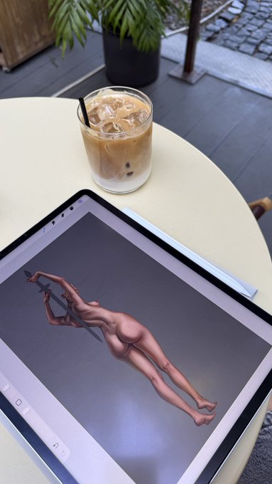 An iPad on a white table displays a 3D rendering of a figure holding a staff, next to an iced coffee, with the text "Good morning New drop soon on @TransientLabs" indicating a new digital art release.