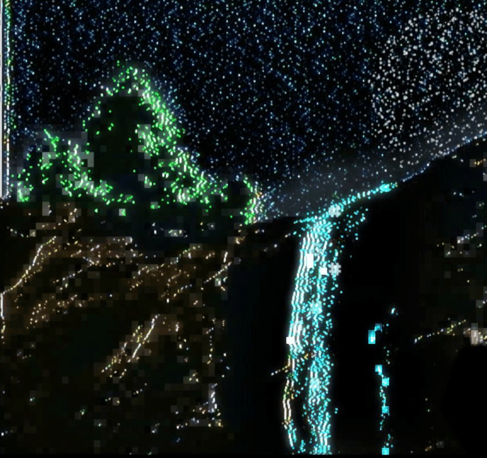 The image features a night scene with a waterfall, stars, and a mountain covered in green lights. The waterfall appears to be falling into a pool below, creating a beautiful display of water and light. The sky above is dark, but the waterfall adds a vibrant contrast to the scene. In the background, there are stars twinkling against the night sky, enhancing the overall atmosphere of the image.