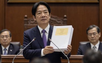 Taiwanese lawmakers are urging the nation to convert $600 billion in forex reserves into Bitcoin and crypto, while acknowledging the rise of "global internet money." The image shows a Taiwanese politician holding up a document, likely related to this proposal.