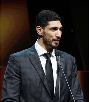 Enes Kanter Freedom, pictured speaking at a podium, has declared for the 2027 WNBA Draft with a 32% chance of being drafted according to Polymarket.