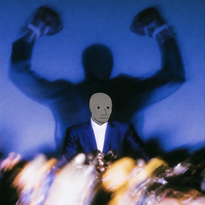 A man in a blue suit with a featureless gray mask covering his face stands against a blue background, with a large dark shadow behind him raising its fists and a crowd blurred in the foreground.