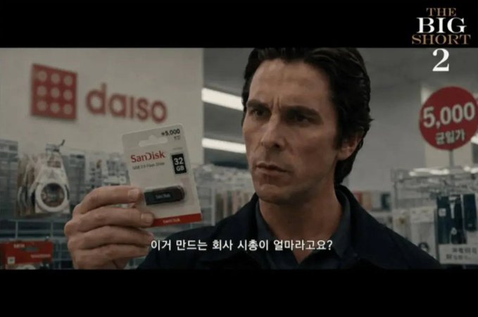 A man in a Daiso store holds up a SanDisk 32GB USB drive priced at ₩5,000, with the Korean subtitle "이거 만드는 회사 사측이 얼마나고요?" ("How much is the company that makes this worth?") suggesting its low price relative to SanDisk's market value, paired with "THE BIG SHORT 2" branding in the corner to humorously frame the $SNDK stock as a short-selling opportunity.