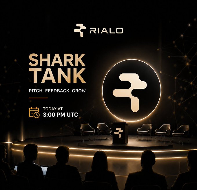 A Rialo promotional graphic for 'SHARK TANK - PITCH. FEEDBACK. GROW.' event scheduled Today at 3:00 PM UTC, showing silhouettes of an audience facing a stage with chairs and the Rialo logo.