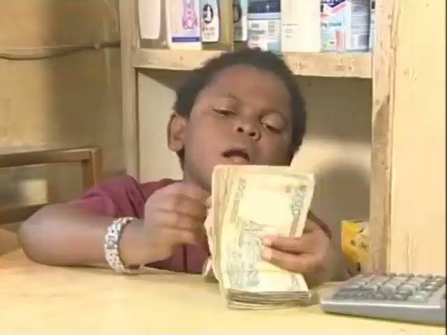 A young child counts a stack of $20 bills at a wooden counter, humorously paired with a caption joking about having "$15" to ape into NFTs on the Robinhood Chain, exaggerating the child's money-counting pose as a crypto investment moment.