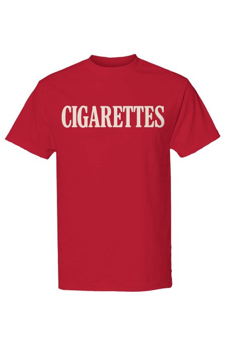 A red short-sleeved t-shirt displays the word "CIGARETTES" in bold cream-colored lettering across the chest, serving as the signature design for the "Cigarettes 2 Cherry Cream" Drop 002 from the 100 Cigarettes collection, where the garment's price fluctuates with Bitcoin.