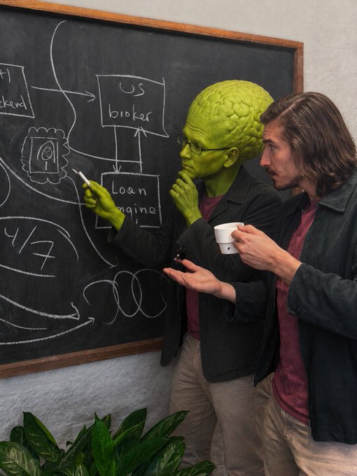 Two men stand before a blackboard covered in flowcharts and text including 'US broker' and 'Loan engine,' discussing while holding markers and a coffee cup.