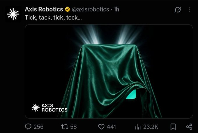 A teaser post from Axis Robotics (@axisrobotics) on X with the text 'Tick, tack, tick, tock...' showing an object draped in green fabric with dramatic lighting.