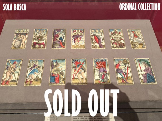 An image of vintage-style tarot cards on display in a museum case, with text reading 'SOLA BUSCA', 'ORDINAL COLLECTION', and a large 'SOLD OUT' overlay.