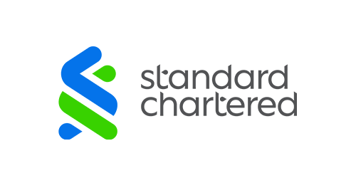 The image displays the Standard Chartered bank logo, featuring a blue and green stylized "S" symbol alongside the "standard chartered" wordmark. This relates to the announcement as Standard Chartered is highlighted as a long-term Ripple partner and the first Global Systemically Important Bank to offer USDC minting and redemption services.